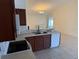 Open kitchen features sleek appliances, tile floor, and a breakfast bar at 369 St Georges Cir, Eagle Lake, FL 33839