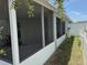 Screened patio with white picket fence and manicured backyard for outdoor living at 369 St Georges Cir, Eagle Lake, FL 33839