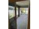 Enclosed back porch provides a relaxing view of the backyard through sliding glass doors at 369 St Georges Cir, Eagle Lake, FL 33839
