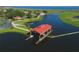 Aerial view of a community boat dock house next to a beautiful lake, complemented by lush greenery and scenic water views at 3881 Shoreside Dr, Kissimmee, FL 34746