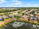 Aerial view of the home with lake, private dock, luscious landscaping, well maintained lawn, and community at 3881 Shoreside Dr, Kissimmee, FL 34746