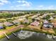Aerial view of a property with a lake view, outlined in red, surrounded by other homes at 3881 Shoreside Dr, Kissimmee, FL 34746