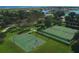 Aerial view of community basketball and tennis courts, offering recreational opportunities amidst beautifully landscaped surroundings at 3881 Shoreside Dr, Kissimmee, FL 34746