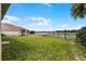The backyard has a well-maintained lawn and backs up to a lake with a private fence and outdoor space at 3881 Shoreside Dr, Kissimmee, FL 34746