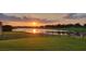 Beautiful sunset view overlooking the lake from the lush green backyard at 3881 Shoreside Dr, Kissimmee, FL 34746