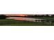 Enjoy the serene lake views and stunning sunset from your backyard at 3881 Shoreside Dr, Kissimmee, FL 34746