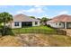 Spacious backyard with a screen patio, privacy fence, and a well-manicured lawn create an inviting space at 3881 Shoreside Dr, Kissimmee, FL 34746