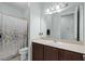 Bathroom with single vanity, dark wood cabinets, light countertops and shower with shower curtain at 3881 Shoreside Dr, Kissimmee, FL 34746