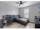 Bedroom featuring wood floors, gray walls, ceiling fan, and a window for natural light at 3881 Shoreside Dr, Kissimmee, FL 34746