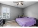 Bedroom with luxury wood floors, gray walls, black dresser, and a window for natural light at 3881 Shoreside Dr, Kissimmee, FL 34746