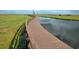 Community boardwalk surrounded by lush landscape and water view at 3881 Shoreside Dr, Kissimmee, FL 34746