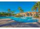 A beautiful community pool with a clear blue sky background and palm trees providing shade and a tropical atmosphere at 3881 Shoreside Dr, Kissimmee, FL 34746