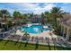 Stunning community pool featuring a beautiful fountain, lounge chairs, palm trees, and a clubhouse creating a resort-style experience at 3881 Shoreside Dr, Kissimmee, FL 34746