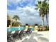 Upscale community pool featuring lounge chairs, meticulously maintained landscaping, and a relaxing resort-style ambiance at 3881 Shoreside Dr, Kissimmee, FL 34746