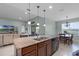 Kitchen with granite island, stainless dishwasher, and view to dining and living room at 3881 Shoreside Dr, Kissimmee, FL 34746