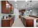 Kitchen island with granite countertops and stainless steel appliances and dark cabinets at 3881 Shoreside Dr, Kissimmee, FL 34746