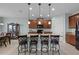 Kitchen island with granite countertop, pendant lights, and dark wood cabinets at 3881 Shoreside Dr, Kissimmee, FL 34746