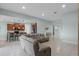 Open living space seamlessly connects to the kitchen, featuring modern furniture, a breakfast bar, and stylish decor at 3881 Shoreside Dr, Kissimmee, FL 34746