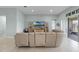 Open living room with a sectional sofa, entertainment center, and sliding glass doors leading to an outdoor patio at 3881 Shoreside Dr, Kissimmee, FL 34746