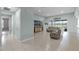 Spacious living room with neutral tile flooring, sliding glass doors to the exterior, and stylish modern decor at 3881 Shoreside Dr, Kissimmee, FL 34746