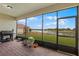 Screened patio with brick floor, grill, potted plants and views of the lake at 3881 Shoreside Dr, Kissimmee, FL 34746
