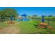 Community playground and picnic area with tables, benches and open green space at 3881 Shoreside Dr, Kissimmee, FL 34746