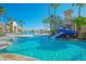 Resort-style pool area with a water slide, palm trees, and a sunny blue sky at 3881 Shoreside Dr, Kissimmee, FL 34746