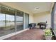 The screened patio features brick flooring, a grill, a fan, and a beautiful view of the lake at 3881 Shoreside Dr, Kissimmee, FL 34746