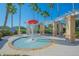 Community splash pad with mushroom water feature, lounge chairs and pergola at 3881 Shoreside Dr, Kissimmee, FL 34746