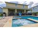 Beautiful backyard pool and spa with covered patio, seating area and grill, great for outdoor relaxation and entertainment at 420 Burma St, Kissimmee, FL 34747