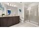 Bathroom with double vanity, granite countertop, walk-in shower and bright lighting at 420 Burma St, Kissimmee, FL 34747