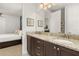 Elegant bathroom featuring double sinks with granite countertops and modern fixtures, next to bedroom at 420 Burma St, Kissimmee, FL 34747