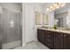 Bathroom with a tiled glass shower, granite countertops and decorative light fixtures at 420 Burma St, Kissimmee, FL 34747