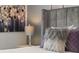 Bedroom featuring a fluffy pillow on a bed with modern decor and an accent wall at 420 Burma St, Kissimmee, FL 34747