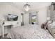 Bright bedroom with a wall-mounted TV, access to the outdoors, and modern decor at 420 Burma St, Kissimmee, FL 34747