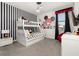 Whimsical ' bedroom features bunk beds, black and white stripes and Mickey Mouse themed decor at 420 Burma St, Kissimmee, FL 34747