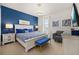 Stylishly decorated bedroom featuring blue accent wall, king bed, and modern furnishings at 420 Burma St, Kissimmee, FL 34747