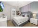 Bedroom featuring a wall-mounted TV, a grey velvet bed, and modern decor at 420 Burma St, Kissimmee, FL 34747