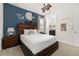 Comfortable bedroom featuring wooden furniture, a 'Never Grow Up' wall art theme, and adjacent bath at 420 Burma St, Kissimmee, FL 34747