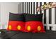 Close-up of Mickey Mouse themed decorative pillows on a bed in a bedroom at 420 Burma St, Kissimmee, FL 34747