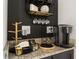 Close-up view of a home coffee station showcasing decor, storage and a Keurig coffee maker on granite countertops at 420 Burma St, Kissimmee, FL 34747