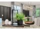 Stylishly appointed dining area showcasing modern decor, contemporary light fixture, and abundant natural light from large windows at 420 Burma St, Kissimmee, FL 34747
