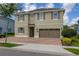 Beautiful two-story home features a paved driveway, attached garage, and manicured landscaping at 420 Burma St, Kissimmee, FL 34747