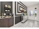 Stylish foyer boasts a coffee bar, mirrored console table, and elegant decor at 420 Burma St, Kissimmee, FL 34747