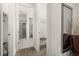 Hallway view to a bright bathroom with a glass shower, and a walk-in closet at 420 Burma St, Kissimmee, FL 34747