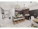 Bright, open kitchen featuring a large center island with counter seating, modern pendant lighting and stainless steel appliances at 420 Burma St, Kissimmee, FL 34747