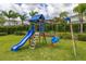 A beautiful backyard featuring a play structure with a slide and swings at 420 Burma St, Kissimmee, FL 34747