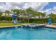 Relaxing pool and spa with a rock waterfall feature and adjacent playground, perfect for enjoying leisurely days outdoors at 420 Burma St, Kissimmee, FL 34747