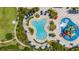 A bird's-eye view showcases the swimming pools and water play areas with colorful slides and lounging spaces at 420 Burma St, Kissimmee, FL 34747