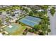 Aerial view of well-maintained tennis courts and a basketball court, offering recreational opportunities for residents at 420 Burma St, Kissimmee, FL 34747